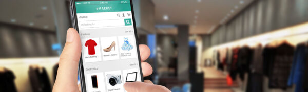 Smart phone online shopping in man hand. Shopping center in back