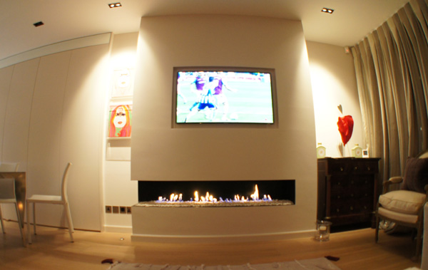 Modern Glass Fireplace Installed Under A Flat Screen Tv Stock Photo Alamy