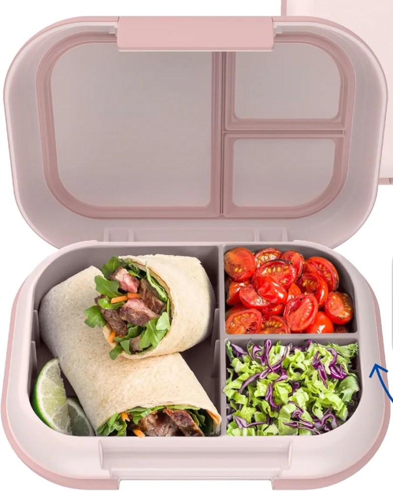 A lunchbox containing wrapped sandwiches, cherry tomatoes, and mixed salad. The lunchbox has two compartments for the wraps and separate sections for the tomatoes and salad.