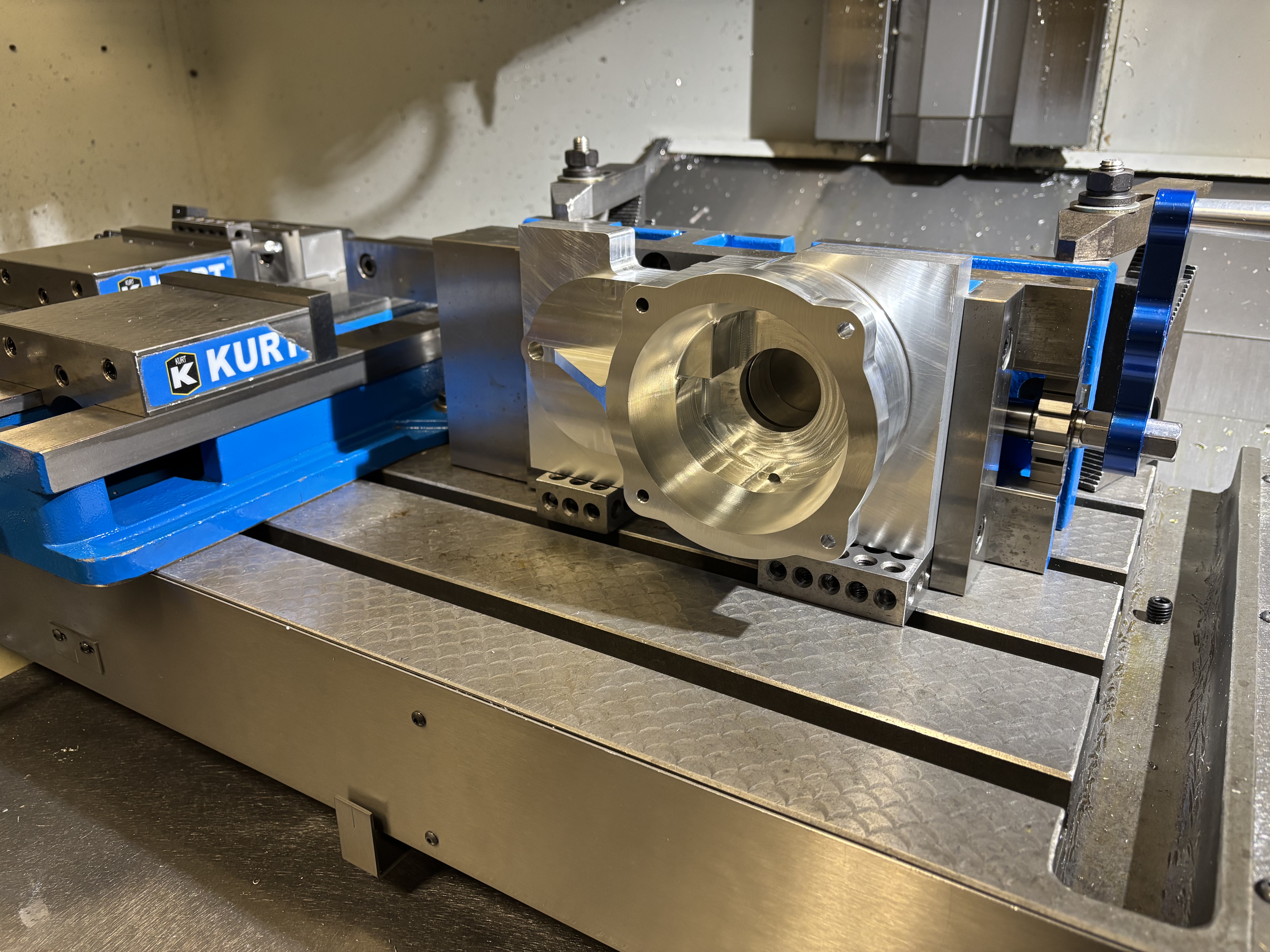 The finished machined aluminium gearbox housing, clamped on the CNC table