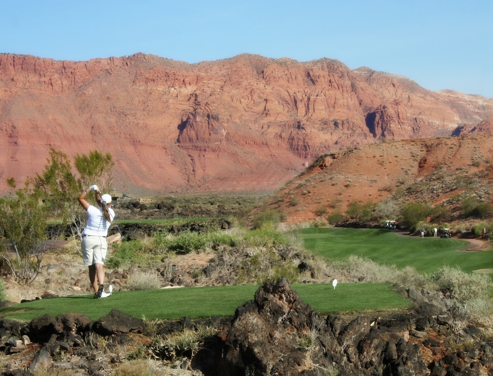 Golfer swinging on a course