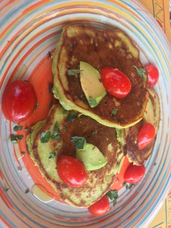 Delicious and health Avocado pancake with small tomatoes and pieces of avocado on top