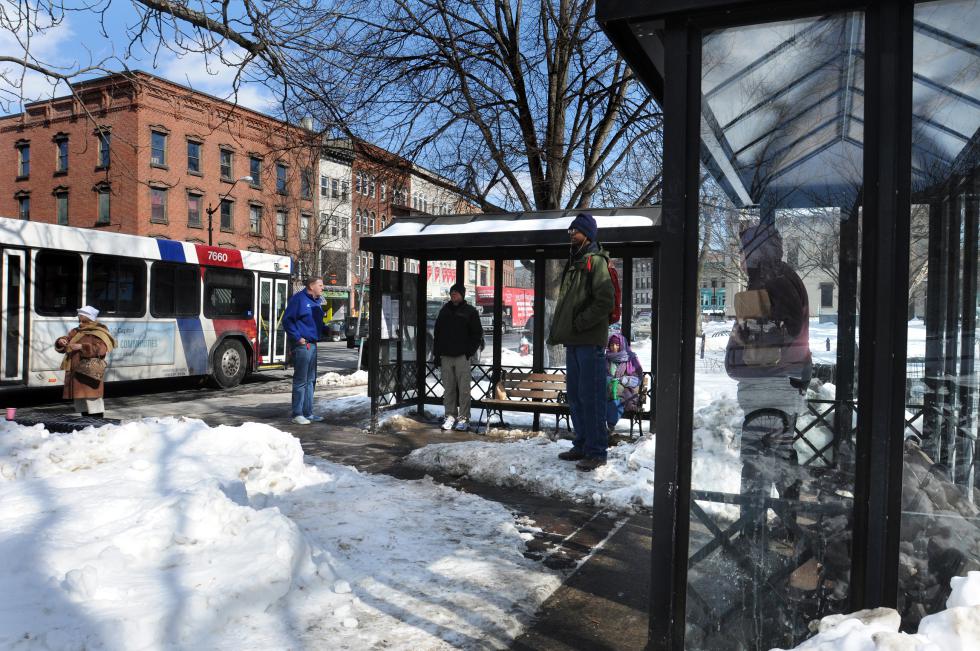 KEVIN GUTTING Personal space observed while waiting for the B48 at the PVTA bus stop in front of the Academy of Music Theatre on Main Street, Northampton, on Wednesday afternoon, February 25, 2015. - KEVIN GUTTING | Daily Hampshire Gazette