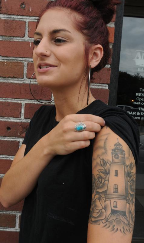 CAROL LOLLIS Kayla Mendrek, an employee at Amy's Place shows the tattoo she has. - Carol Lollis | Daily Hampshire Gazette
