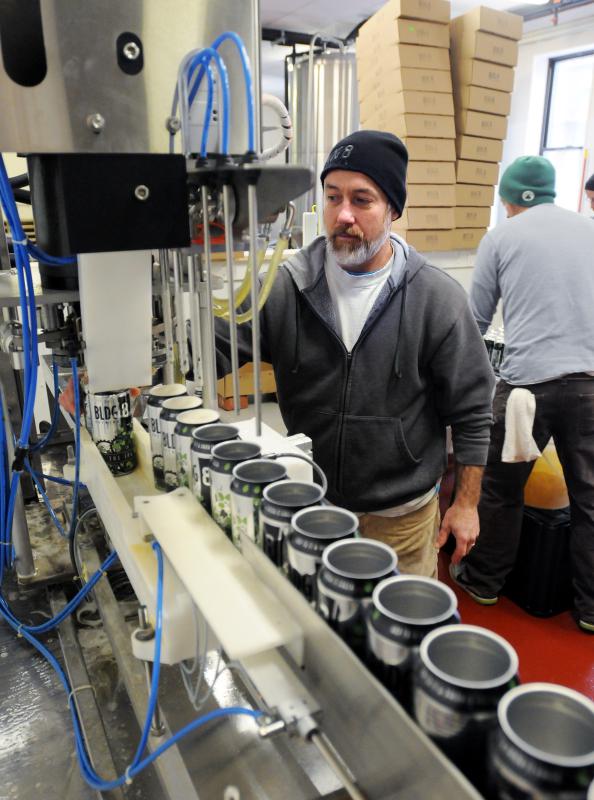 KEVIN GUTTING Brewer Mike Yates works the canning line at Building 8 Brewing in Florence. - KEVIN GUTTING | DAILY HAMPSHIRE GAZETTE