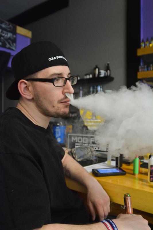 Chris Ballard, of Springfield, exhales vapor at Voltage Vape in Springfield, Tuesday, March 8. - JERREY ROBERTS | DAILY HAMPSHIRE GAZETTE