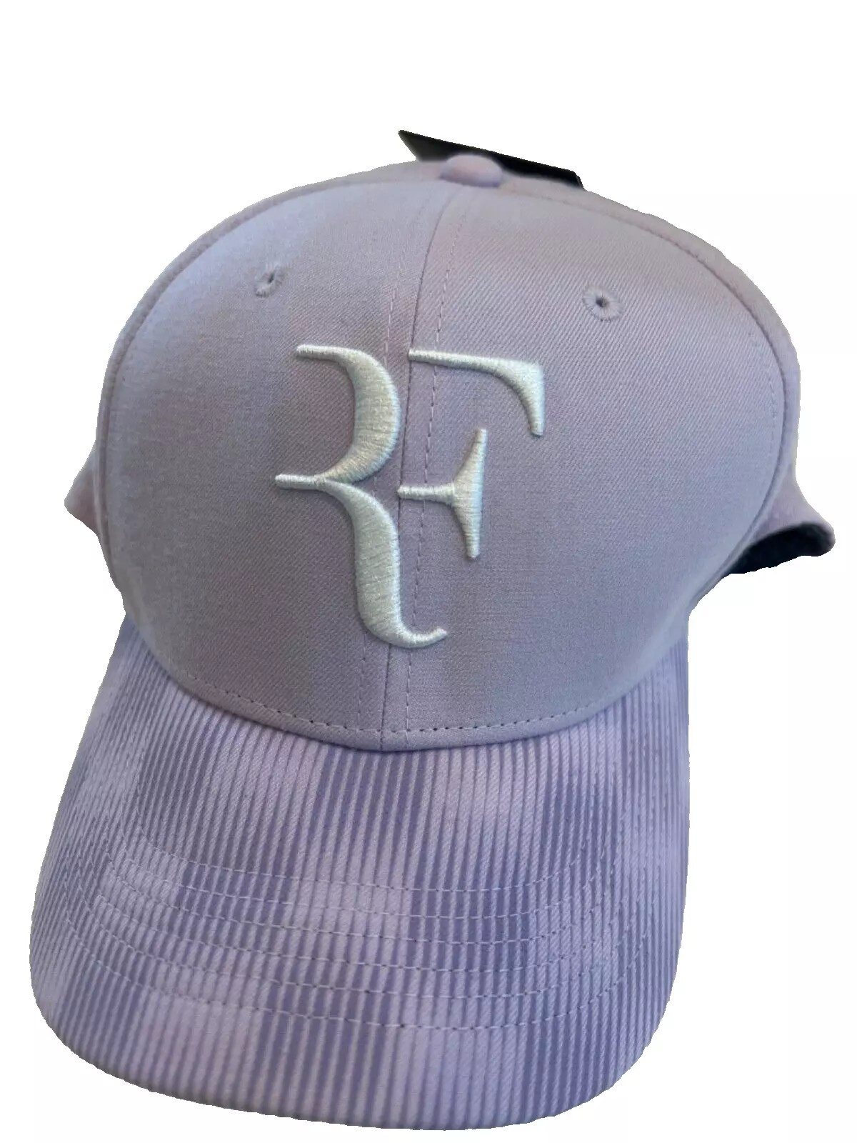 Purple cap with white embroidered initials.