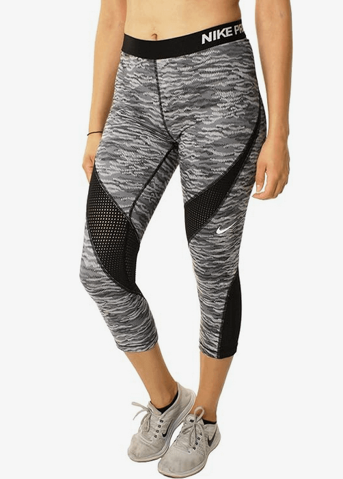 Person wearing patterned leggings and sneakers.