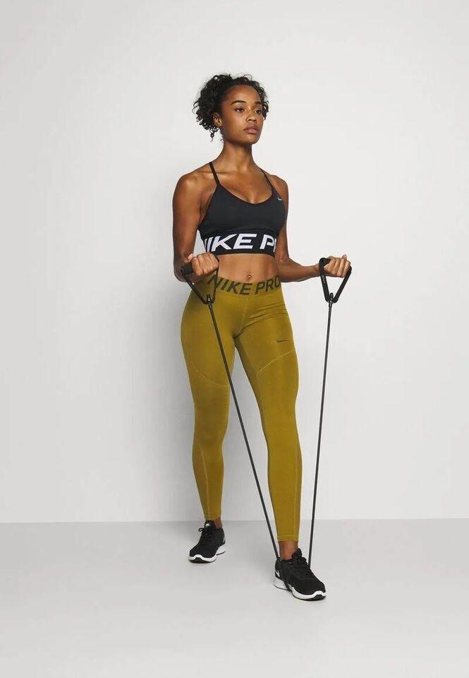 Woman exercising with resistance bands indoors.
