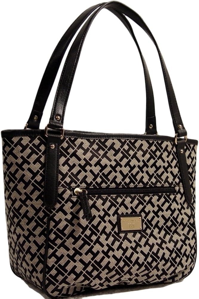 Patterned tote bag with black leather straps.