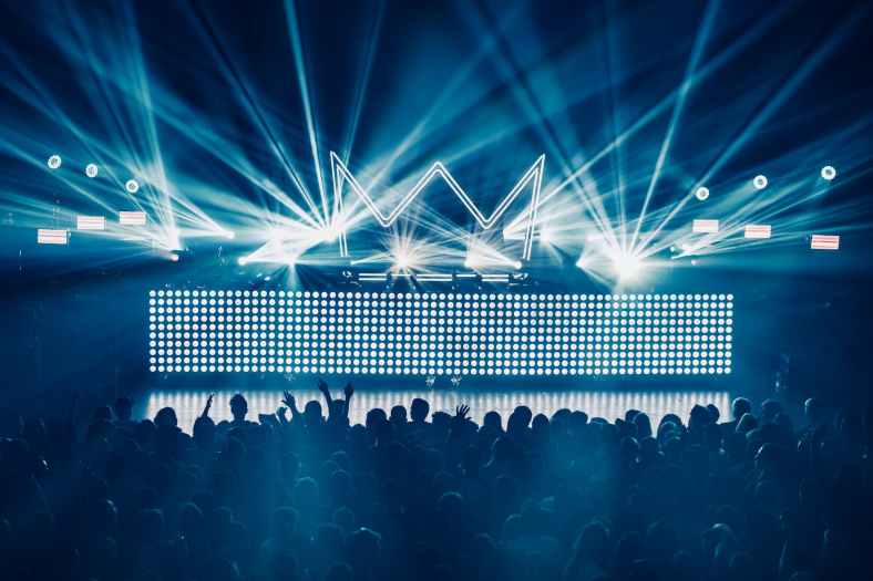 silhouette of dancing people inside club