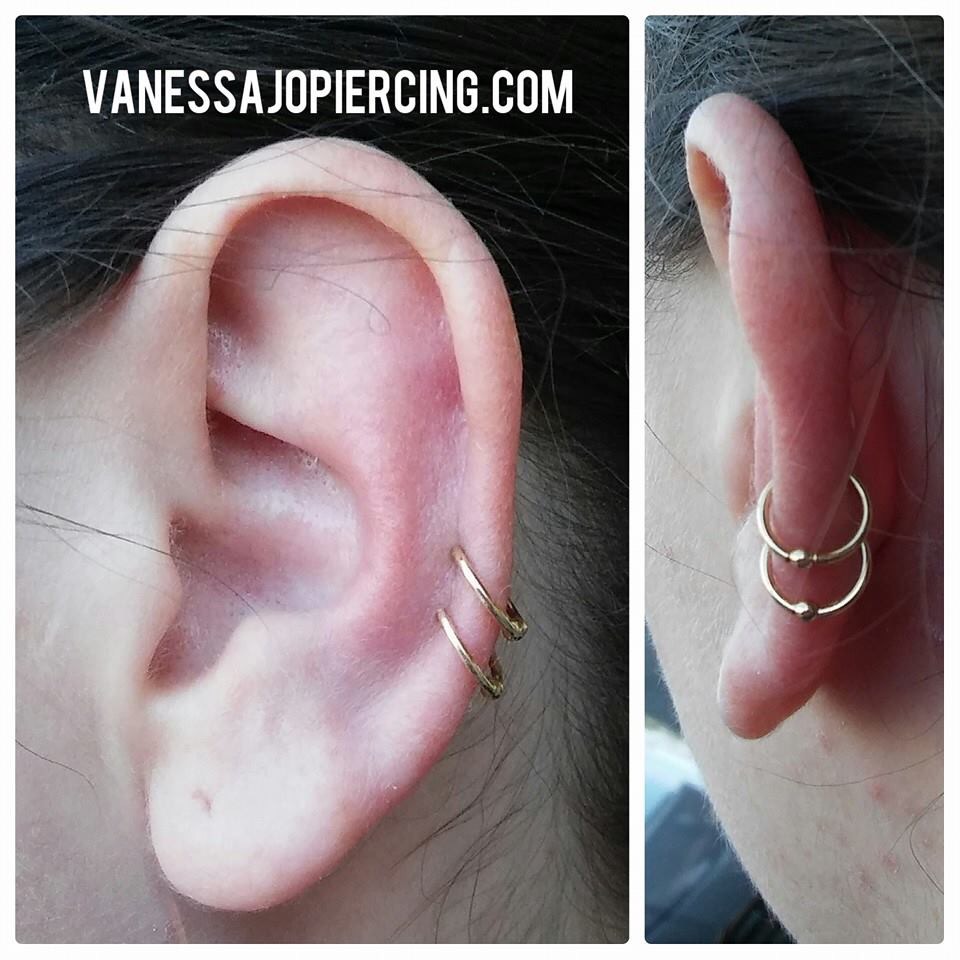 Ear cartilage piercings with yellow gold fixed bead rings