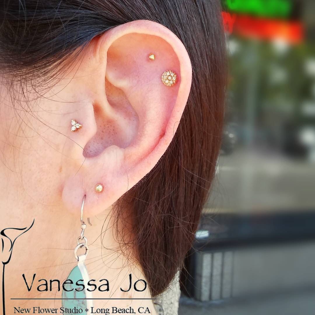 Tragus piercing and ear cartilage piercings wearing 14k yellow gold ends