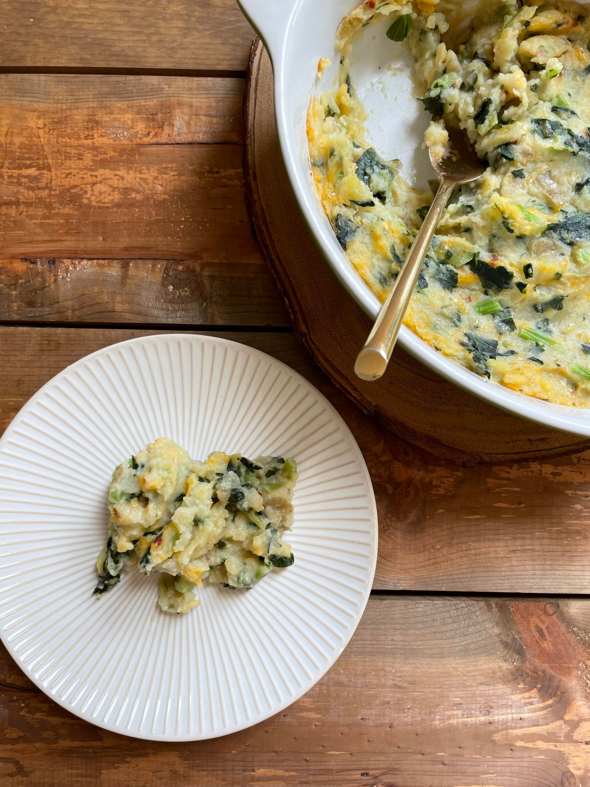 Mashed Potato Casserole in baking dish with serving on plate