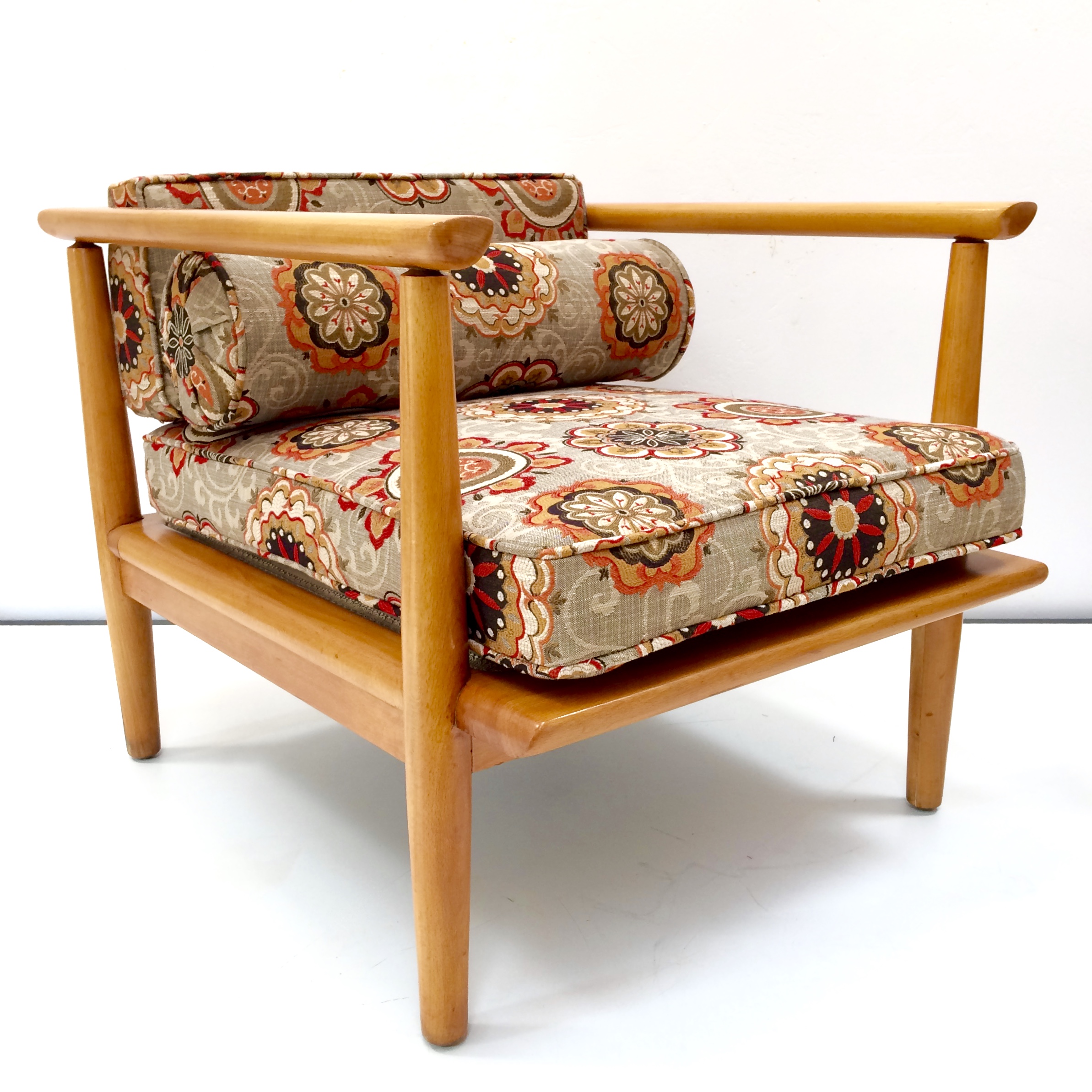 This mid-century chair was made custom by the lumbar-supporting bolster cushion.