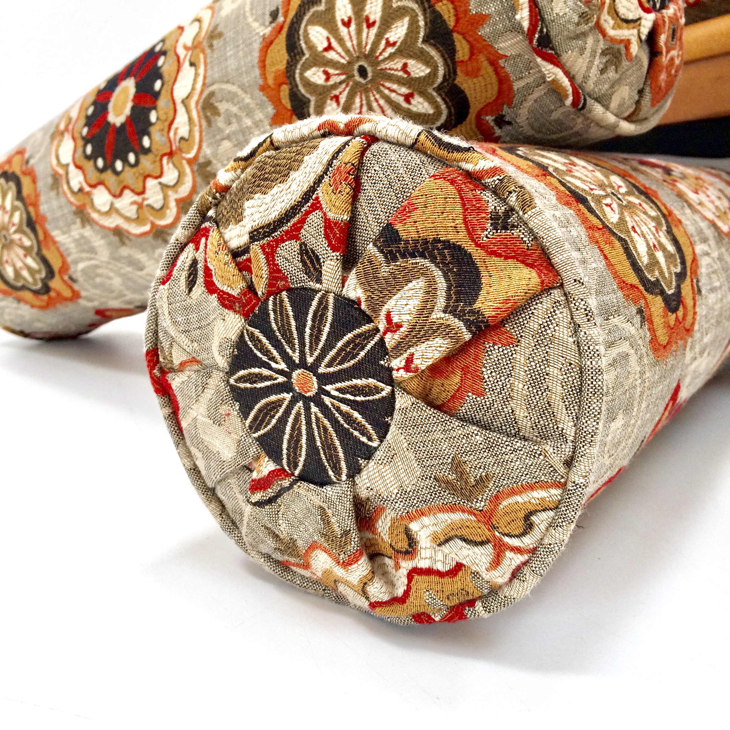 The pleated end piece to this bolster cushion is one of a kind.