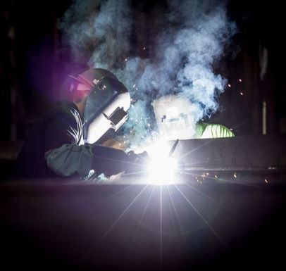 Person welding using protective equipment.