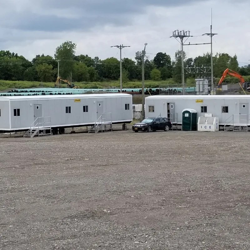 Multiple Versatile Office Trailers units staged on a large gravel site, showing a multi-trailer setup used for ongoing operations and project planning.