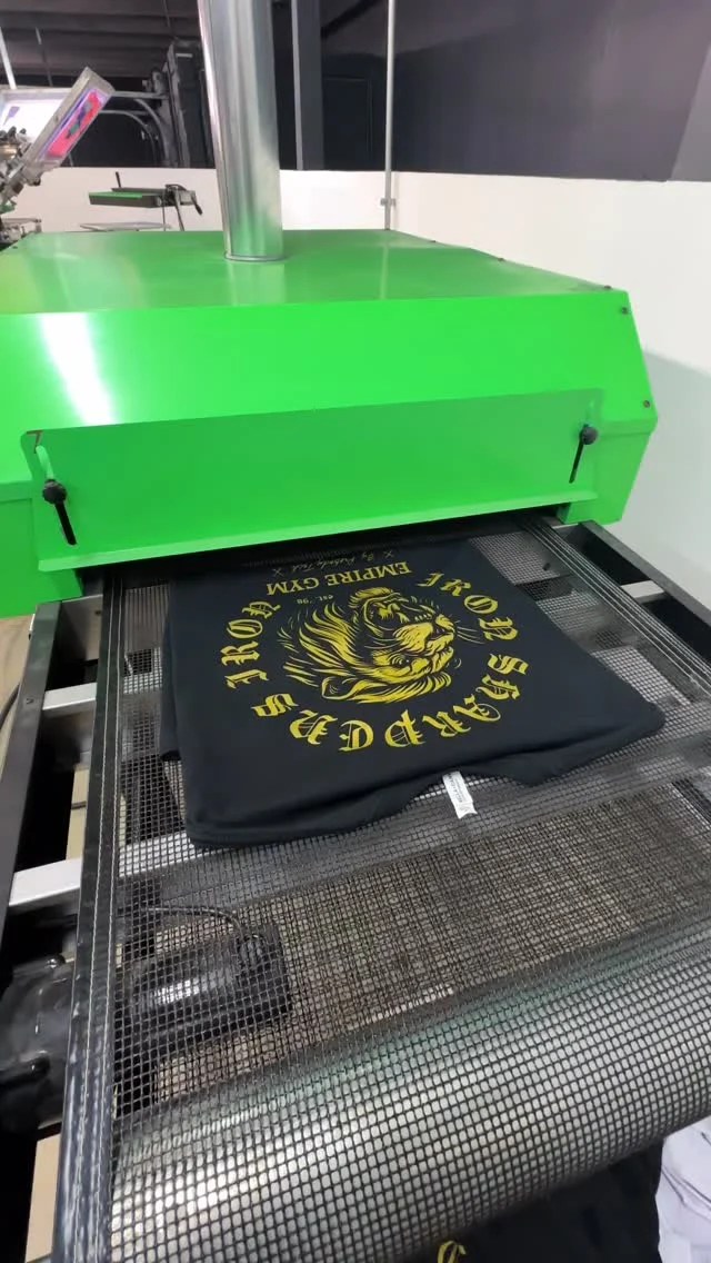 The same screen printed design run in different colorways, fresh out of the dryer