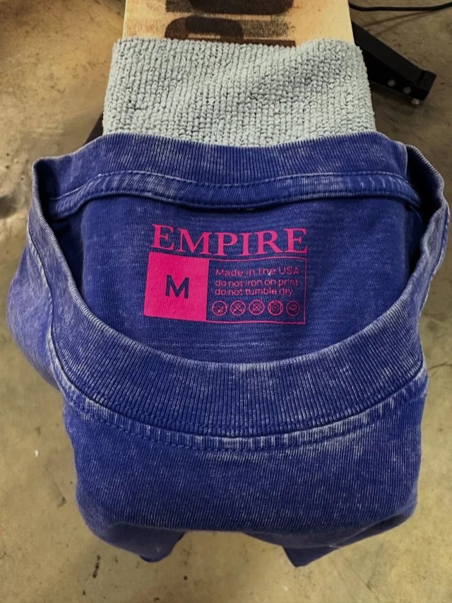 Custom neck tag screen printed in-house for EMPIRE at Vertigo Print Lab