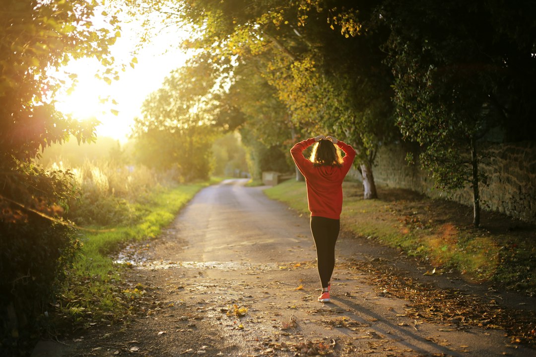 Person moving outdoors, illustrating consistent daily movement and wellness.