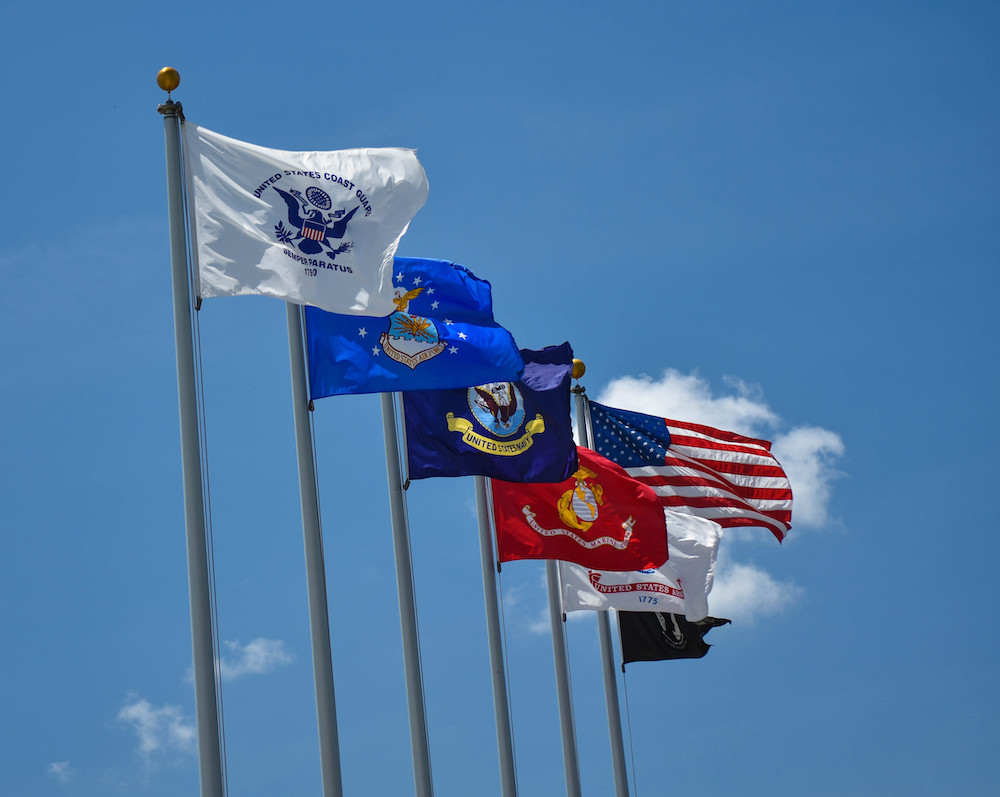 Military Flags Flying Proudly in a Clear Blue Sky