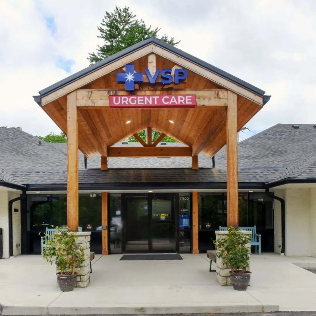 Exterior entrance of a VSP Urgent Care building with wooden portico and signage.