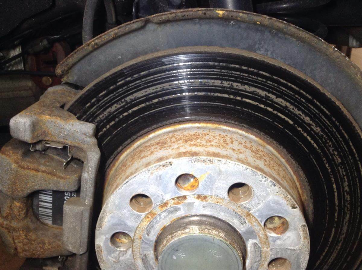 Warped brake rotor showing heat spots and uneven surface wear