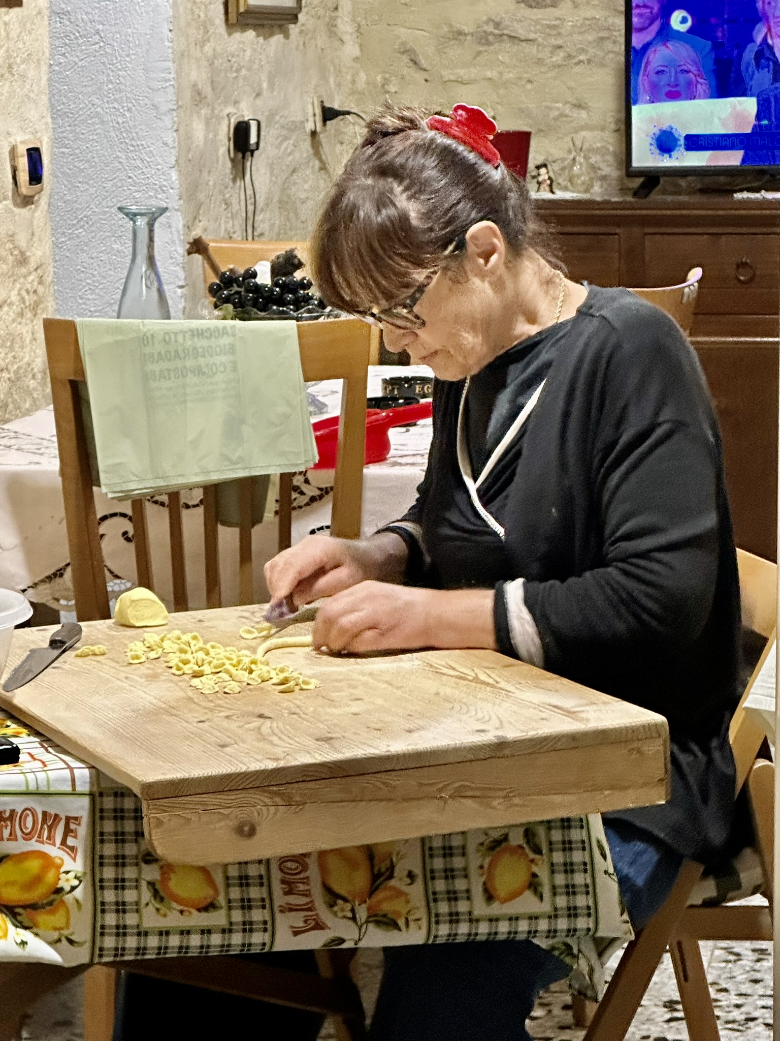 Woman making orecchiette pasta by hand Bari Italy Italian hospitality