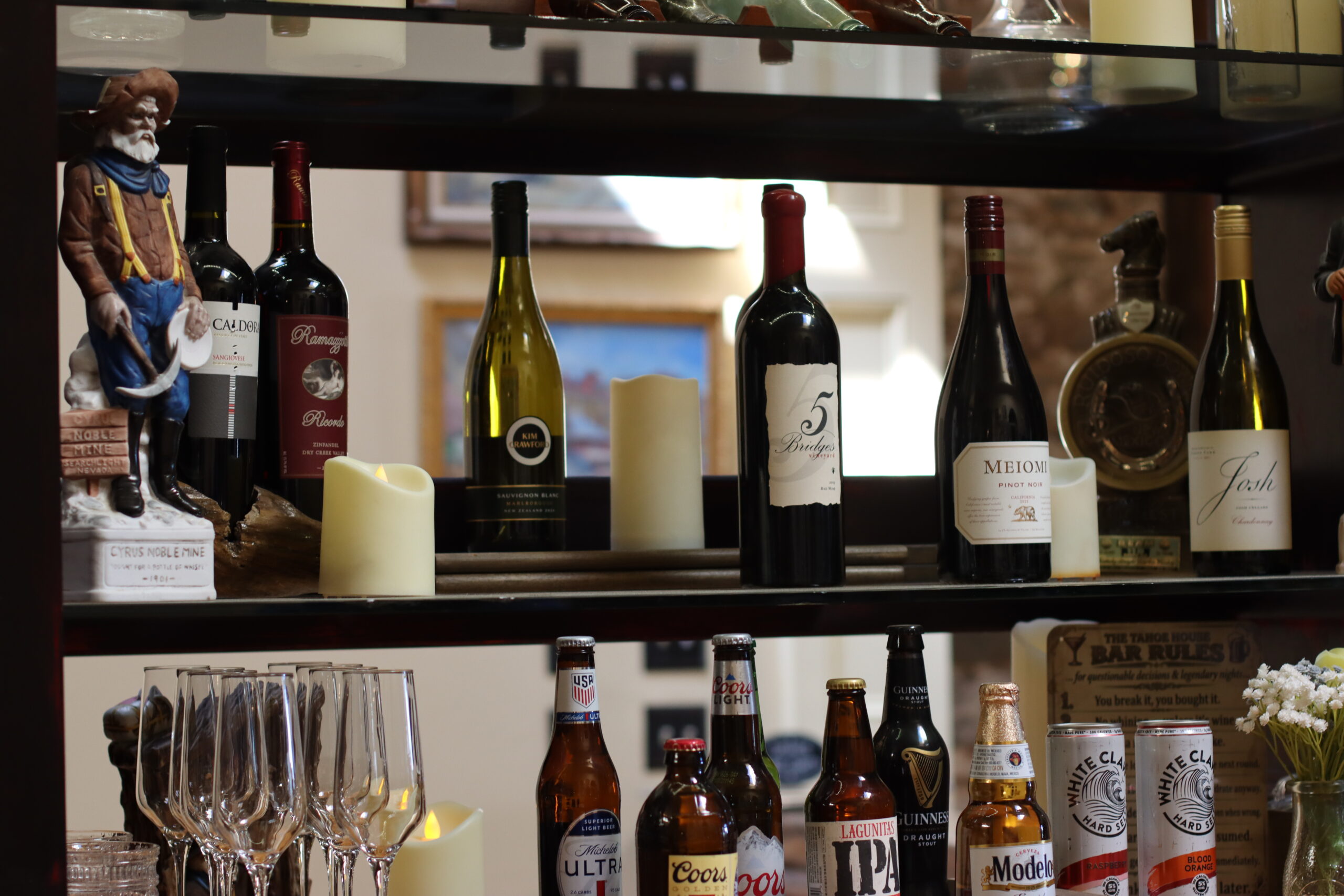 Tahoe House Hotel back bar with curated wine and spirits display, showing the visual storytelling infrastructure that requires trained staff to interpret for guests