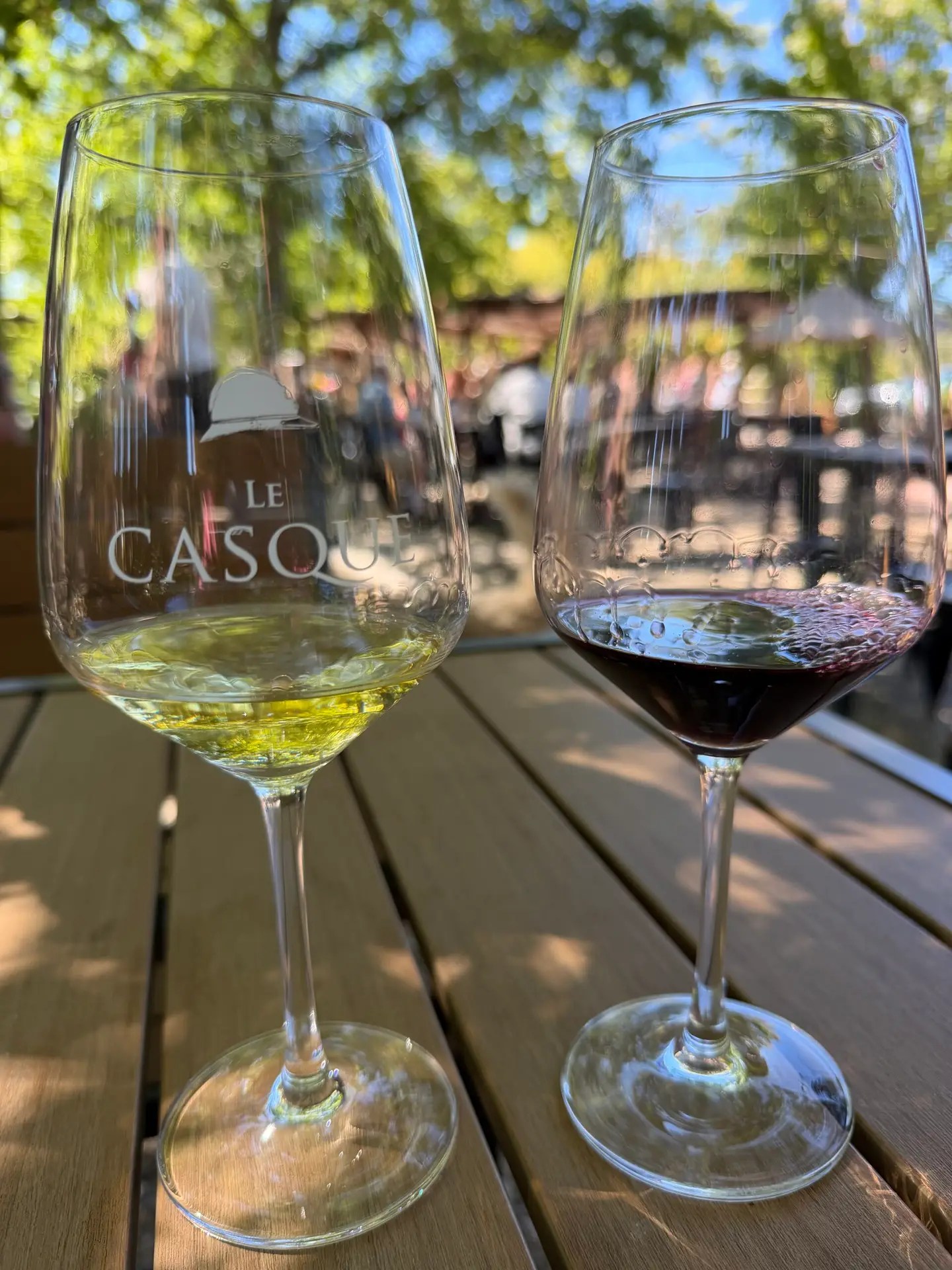 Two small tasting pours in Le Casque glasses on an outdoor table at Casque Wines in Loomis, California.