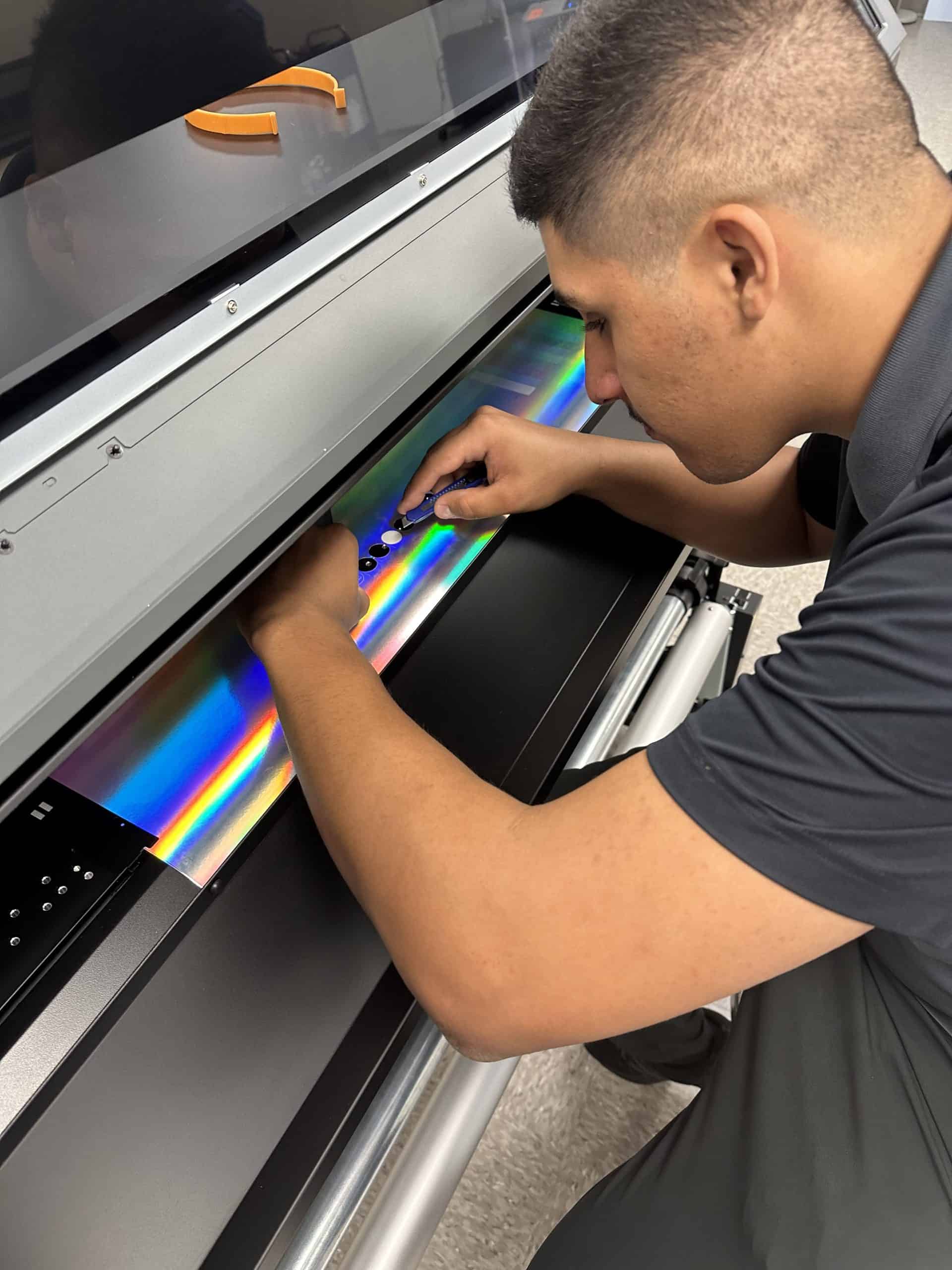 Vibrant print solutions technician operate large-format printer for high-quality custom printing services.
