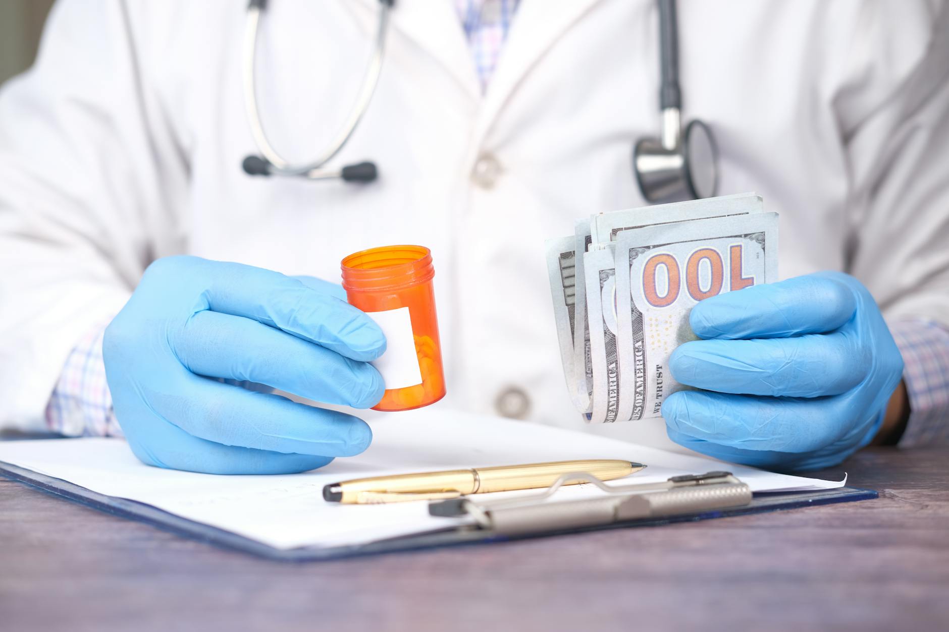 person holding money and pill bottle