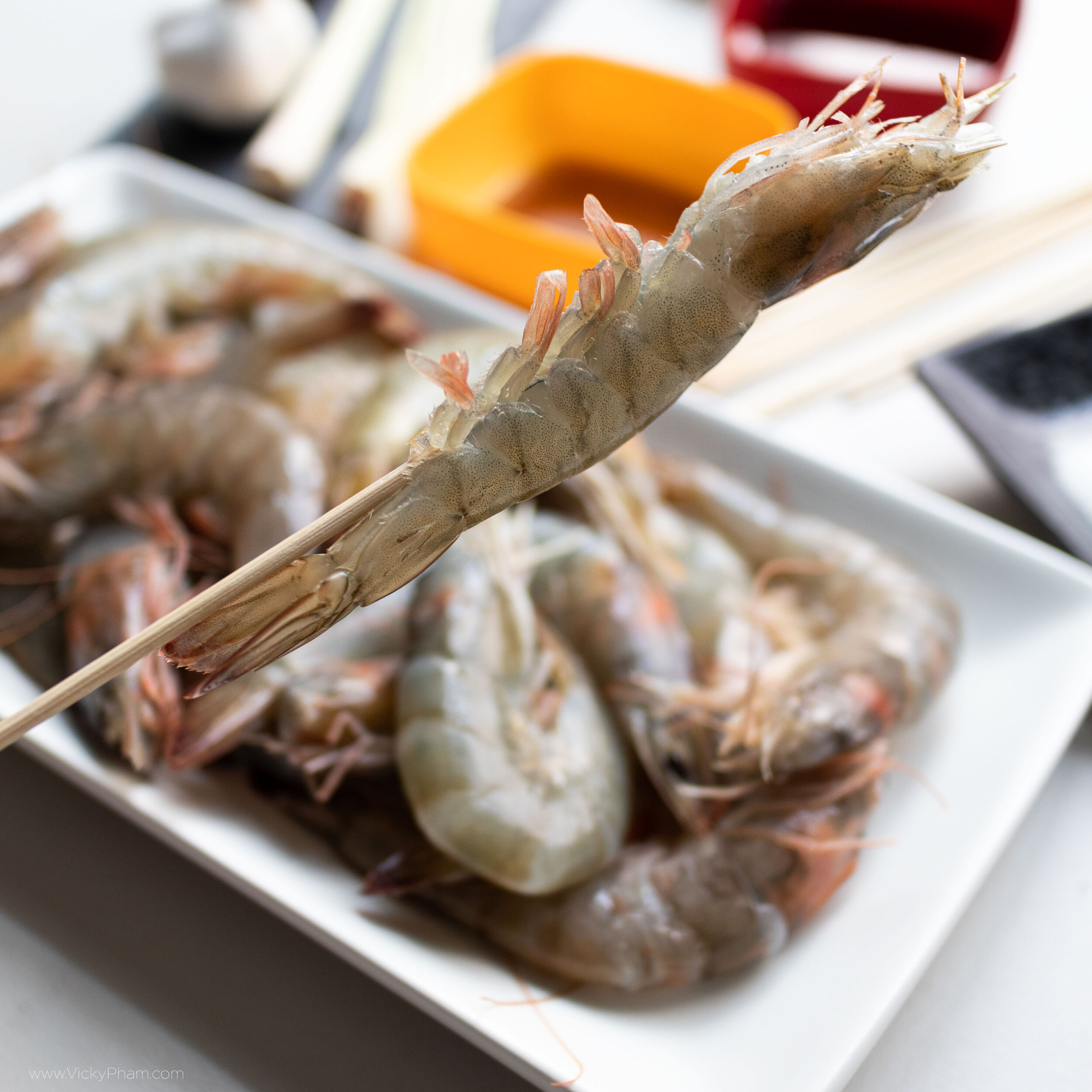 Skewering shrimp for the grill. Start at the tail-end then work your way up.