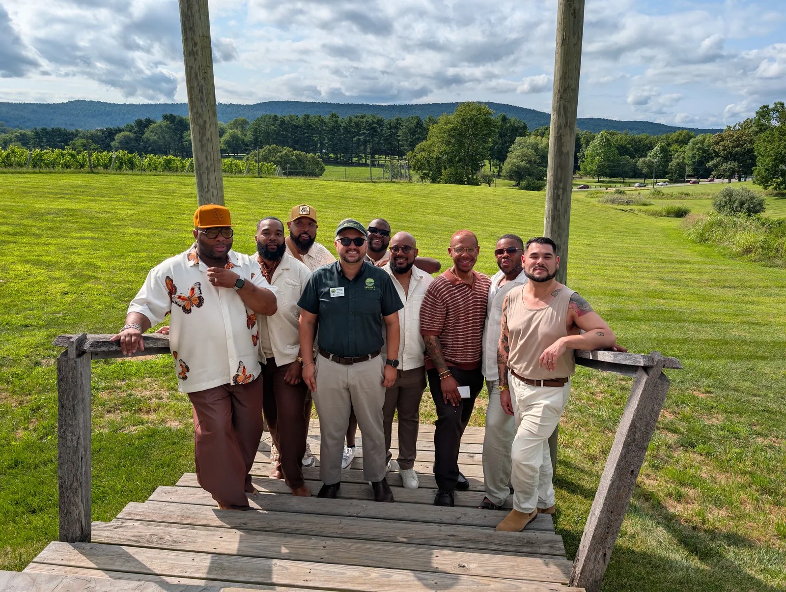 Guests on winery steps with green fields behind