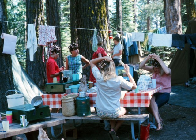 1960s girls camping and putting curlers in their hair