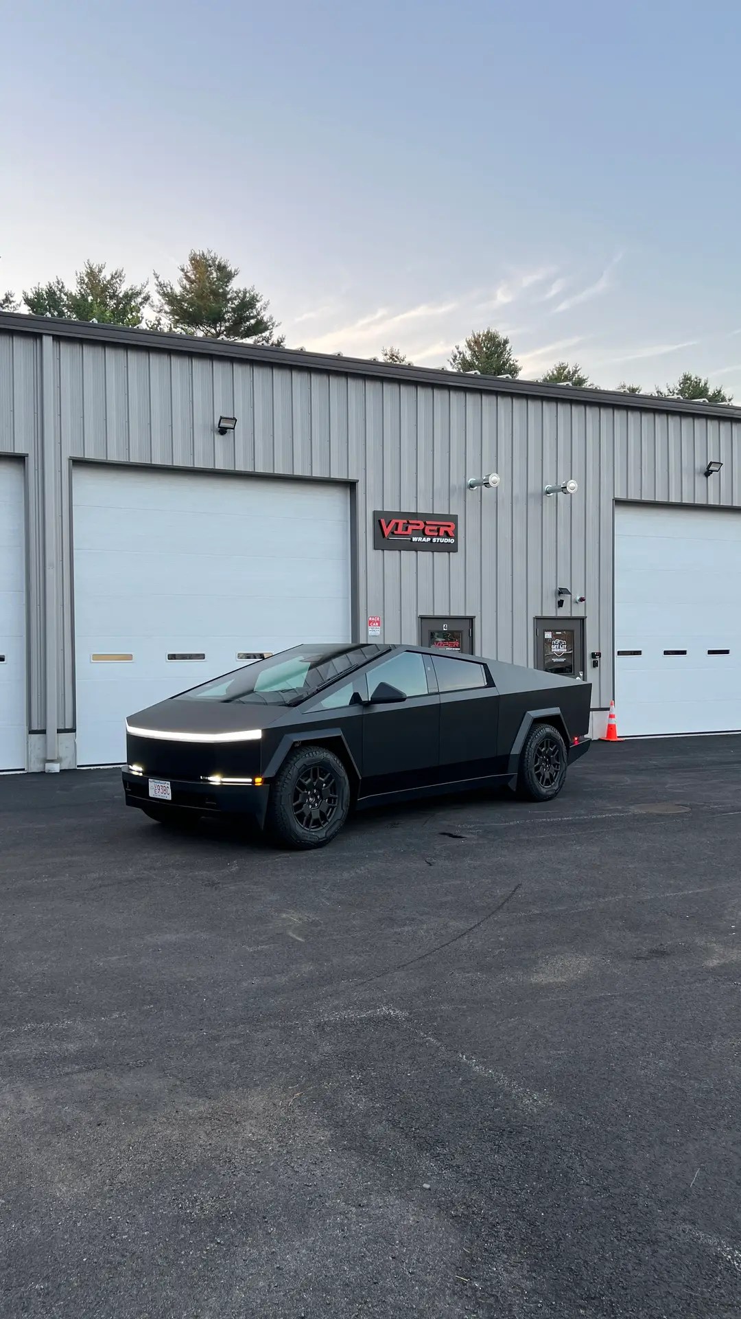 a wrapped tesla cybertruck parked in front of viper wrap studio and car detailing
