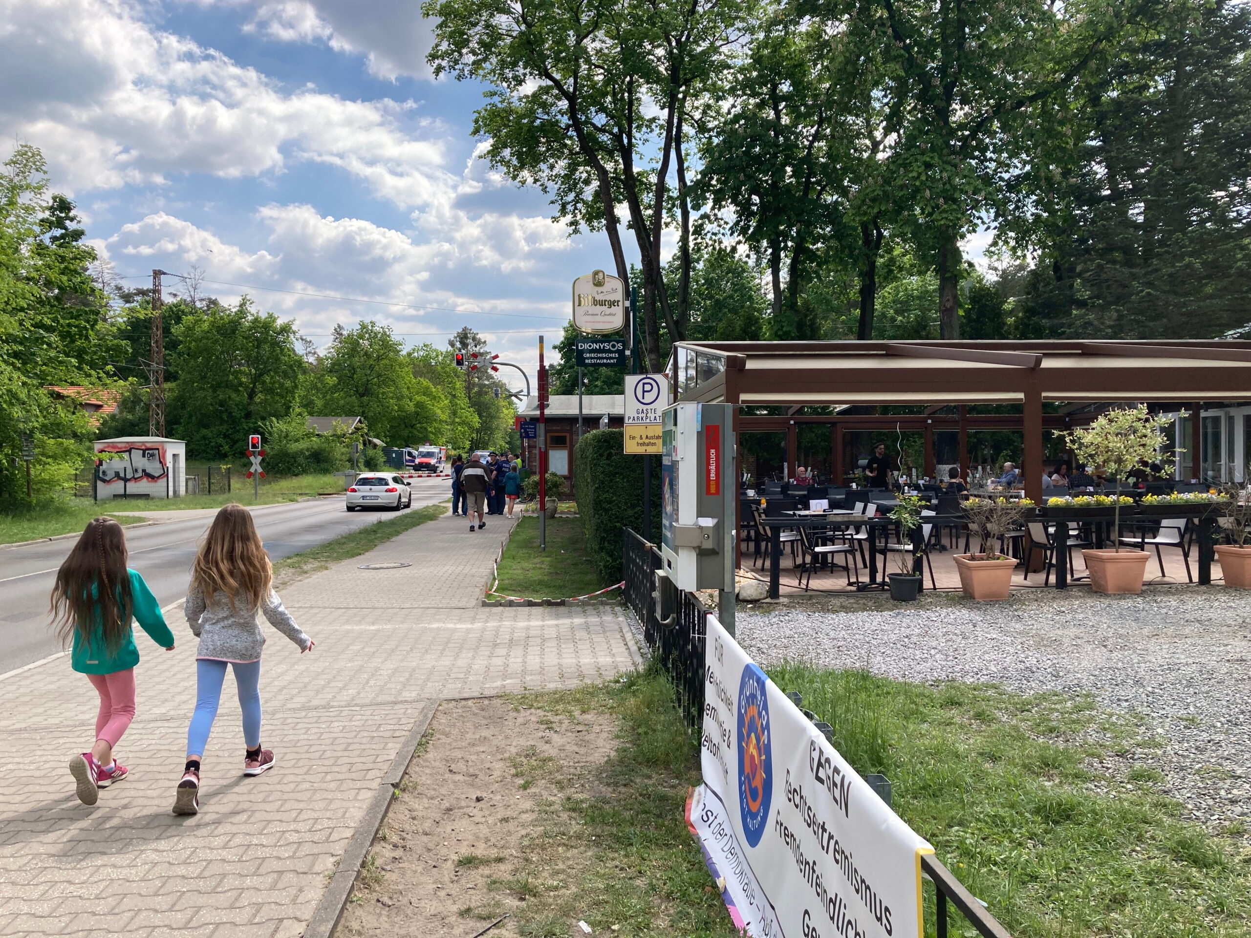 random road somewhere in Brandenburg. Tho girls running or walking on the left-hand-side of the picture