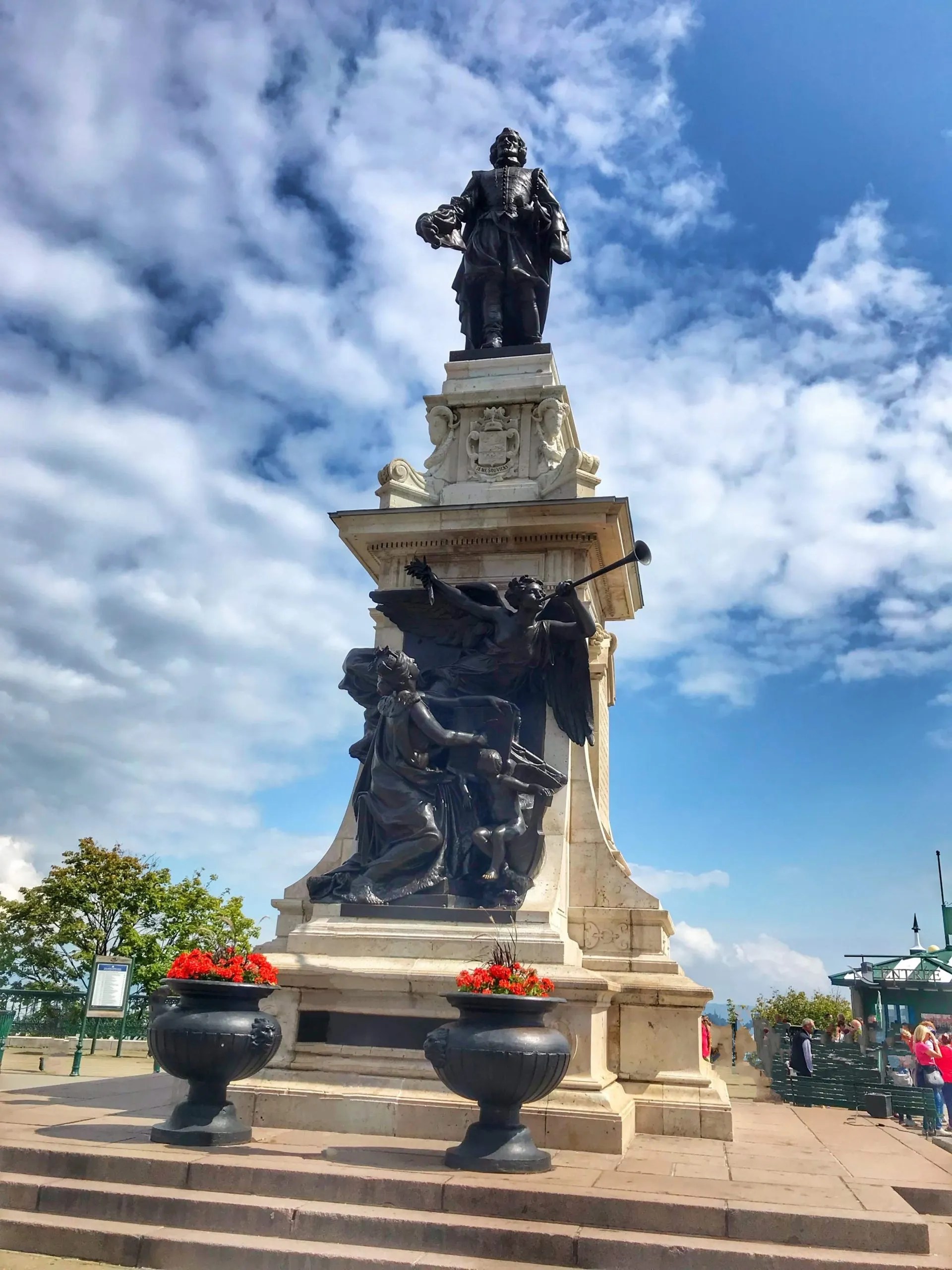 A statue depicting a French Explorer, Champlain, man against a vibrant blue sky.