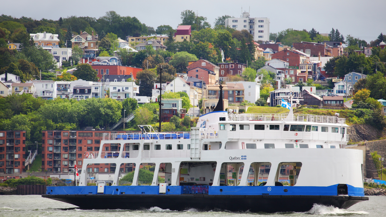A quebec ferry boat in the water.