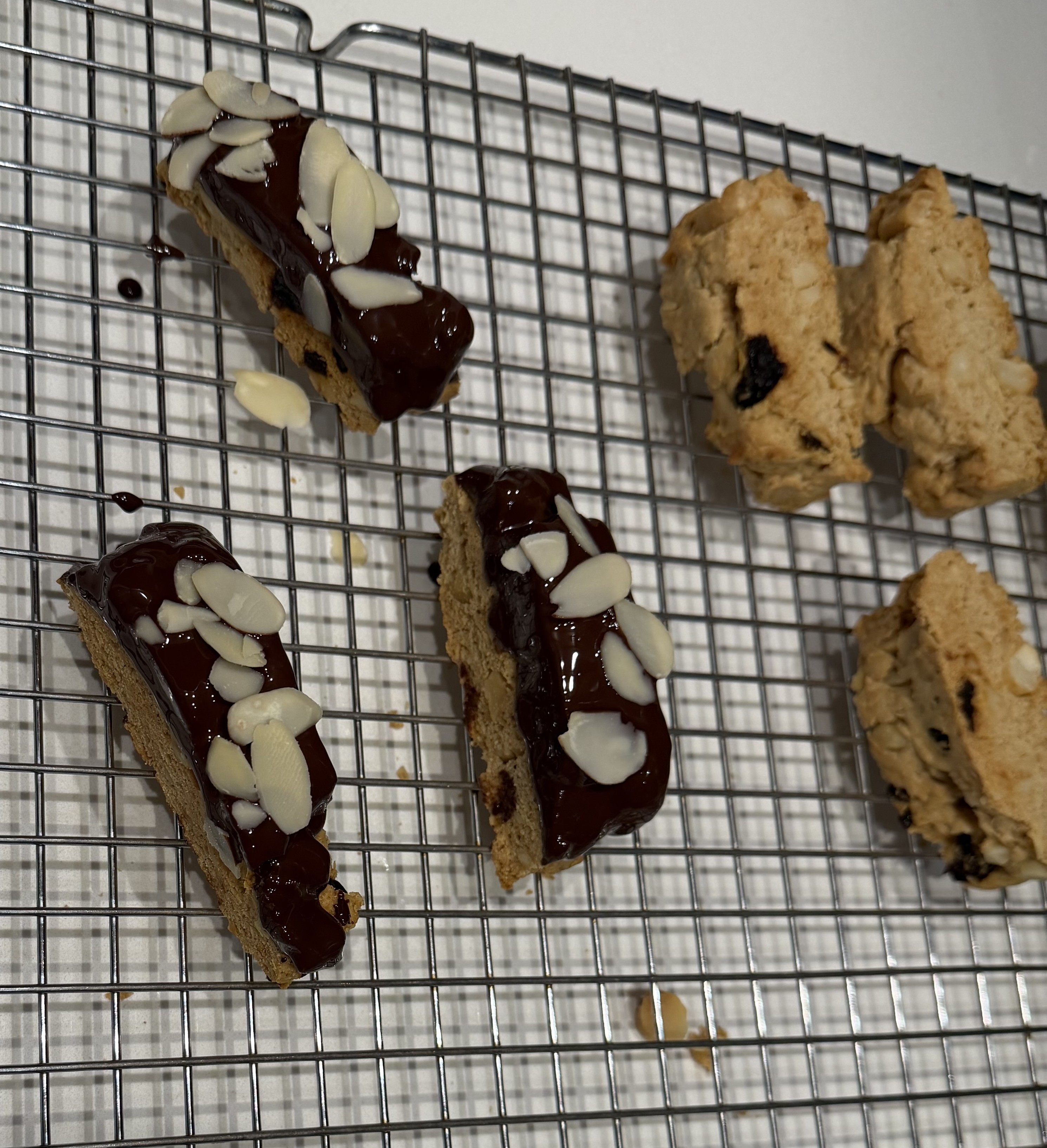 Biscotti topped with chocolate and sliced almonds