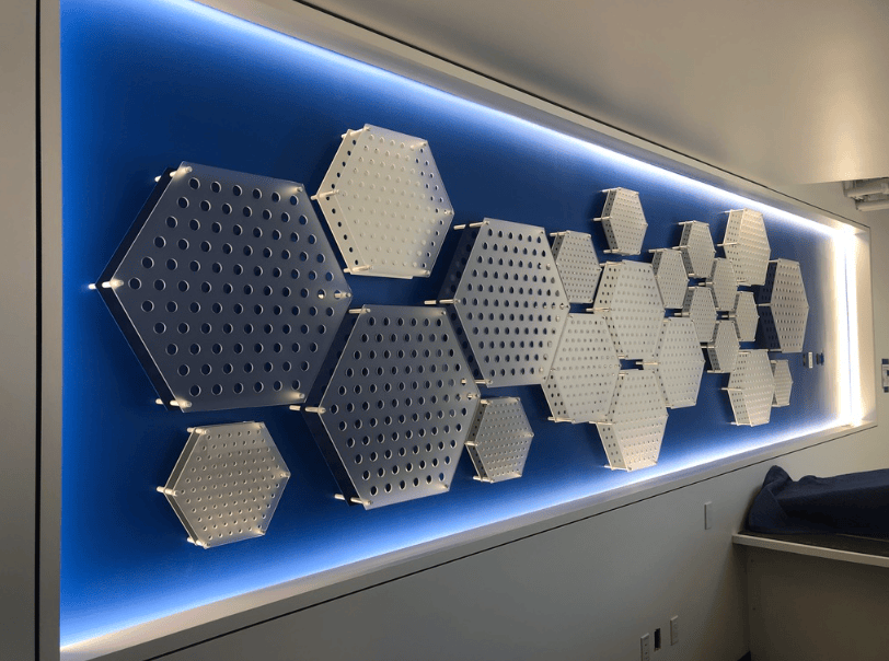 Custom illuminated architectural wall display with dimensional hexagonal panels