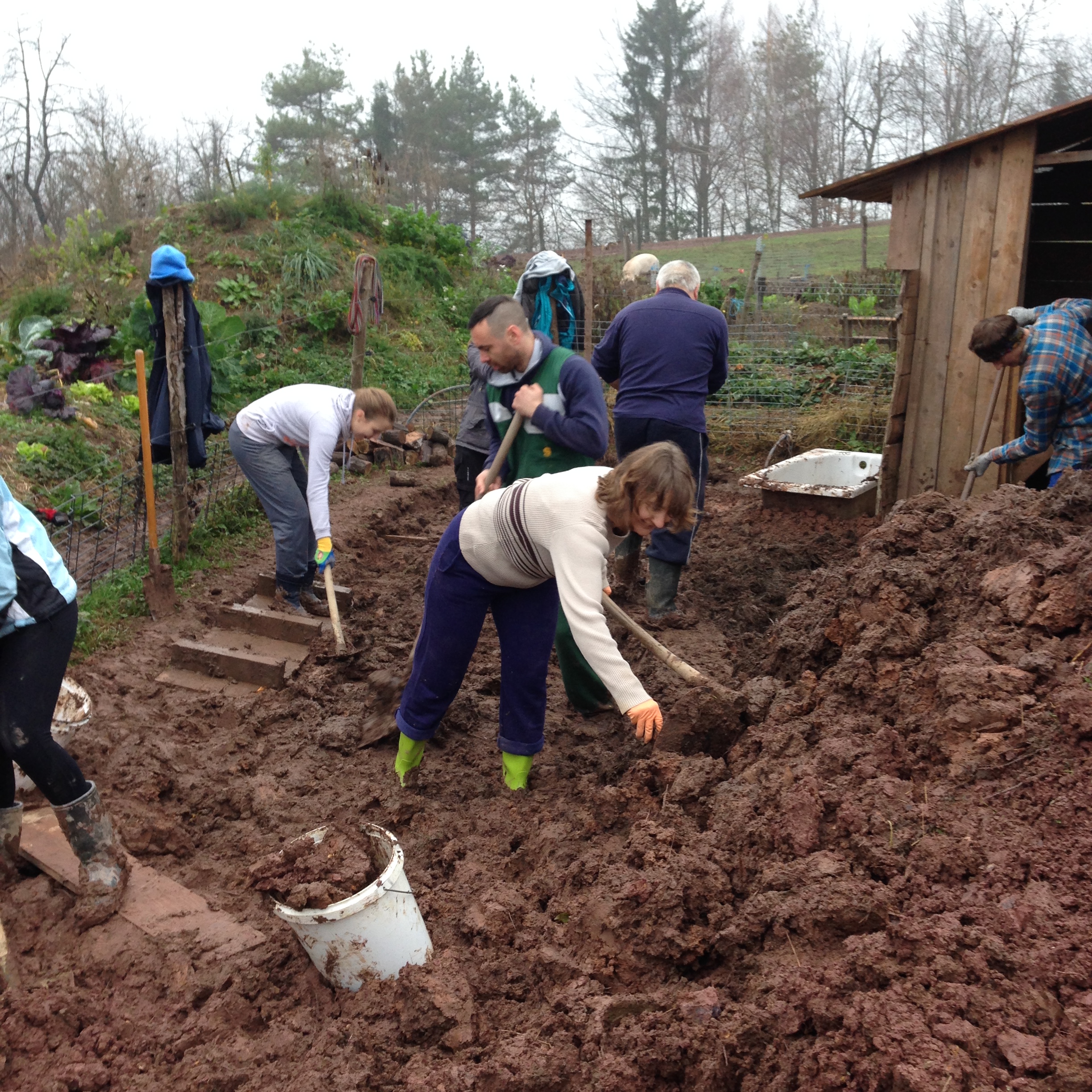 Many hands helped to flatten the surface to lay down gravel
