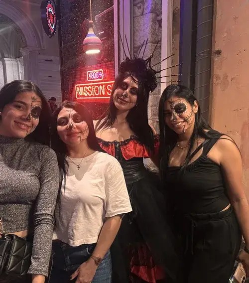Guests with sugar skull face painting at a Day of the Dead party in Athens