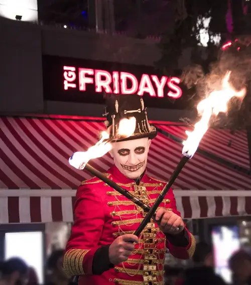 Skeleton ringmaster fire performer with fire torches for Halloween