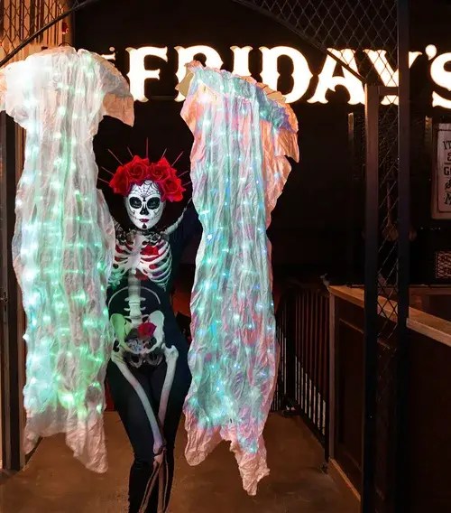 Illuminated sugar skull character with glowing fan veils for Halloween