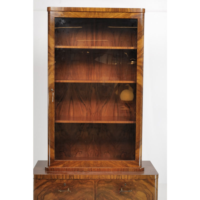 Tall walnut display cabinet with a glass front and five wooden shelves on a matching base cabinet.]','