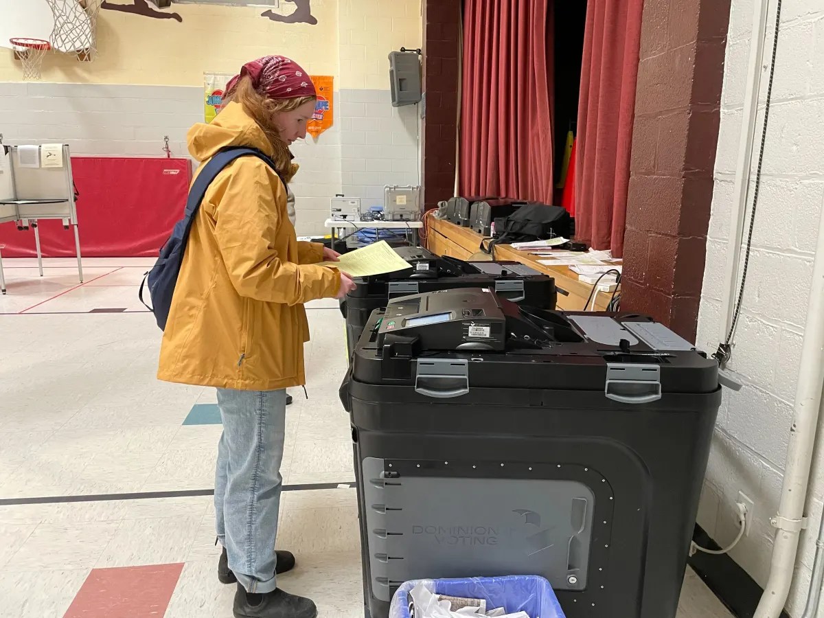 A woman holding her ballot.