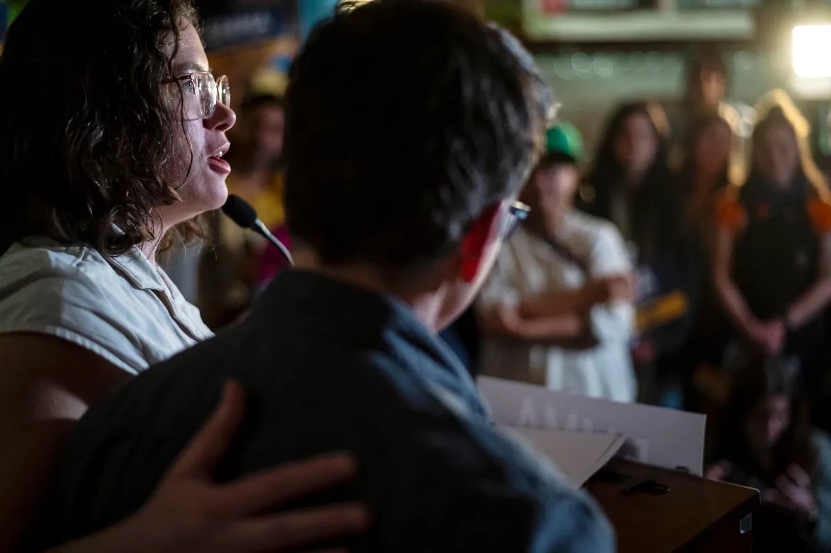 A woman holding a microphone.