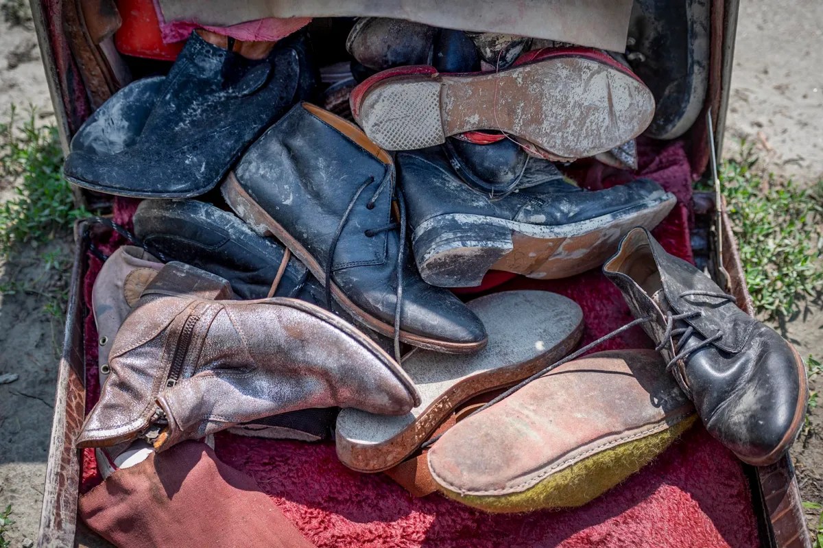 a suitcase with a lot of shoes in it.